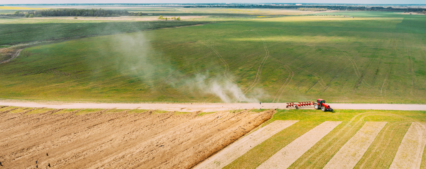 An aerial shot of a tractor ploughing a field