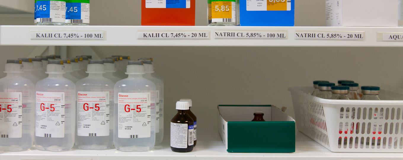 A close-up photo of a medical shelf full of bottles, medicines and storage containers.